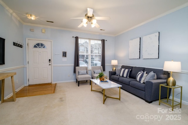 living room with ceiling fan, light colored carpet, and ornamental molding