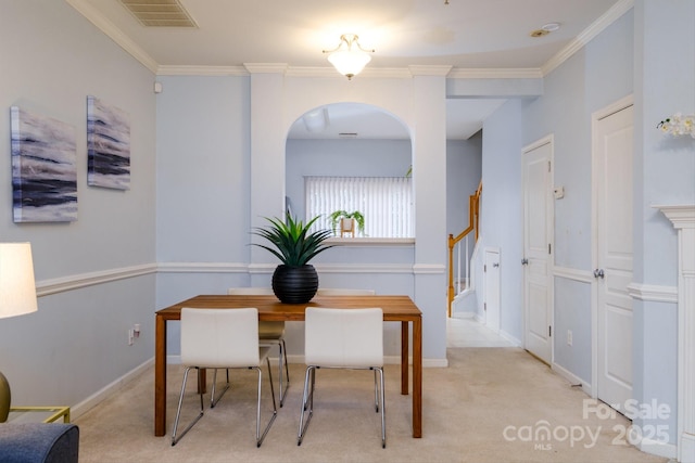 carpeted dining space with ornamental molding