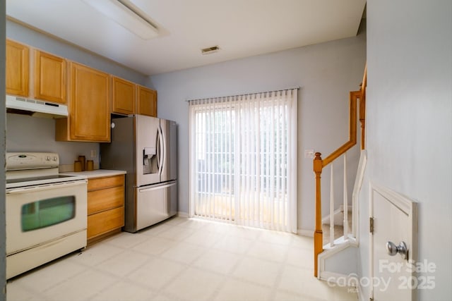 kitchen featuring stainless steel refrigerator with ice dispenser and electric range