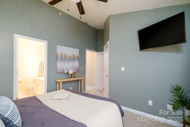 carpeted bedroom with ceiling fan and ensuite bath