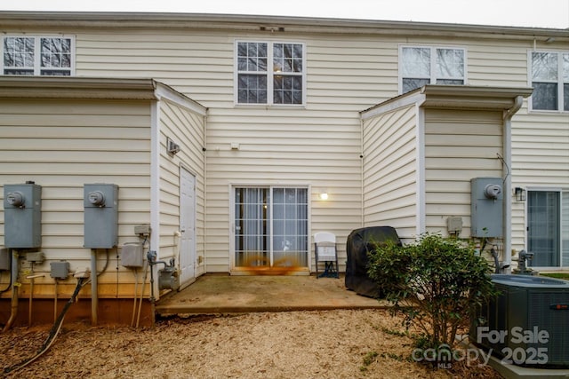 back of house with a patio area and central AC unit