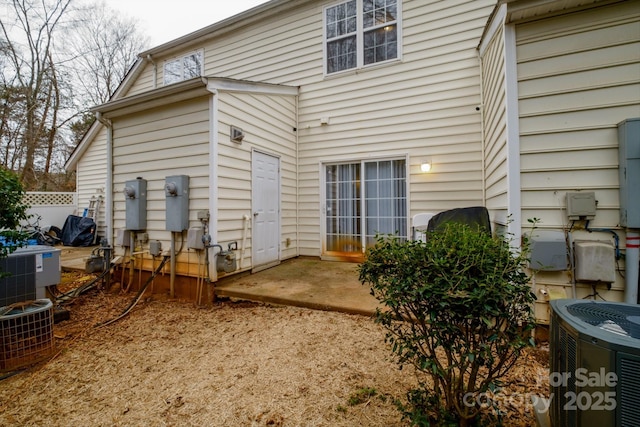 back of house with central air condition unit and a patio