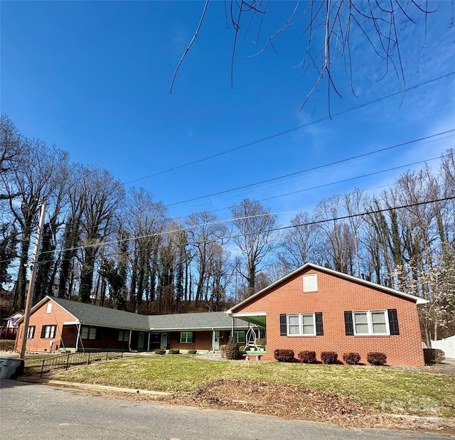 single story home with a carport and a front lawn