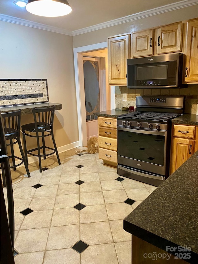 kitchen featuring crown molding, stainless steel range with gas stovetop, and tasteful backsplash