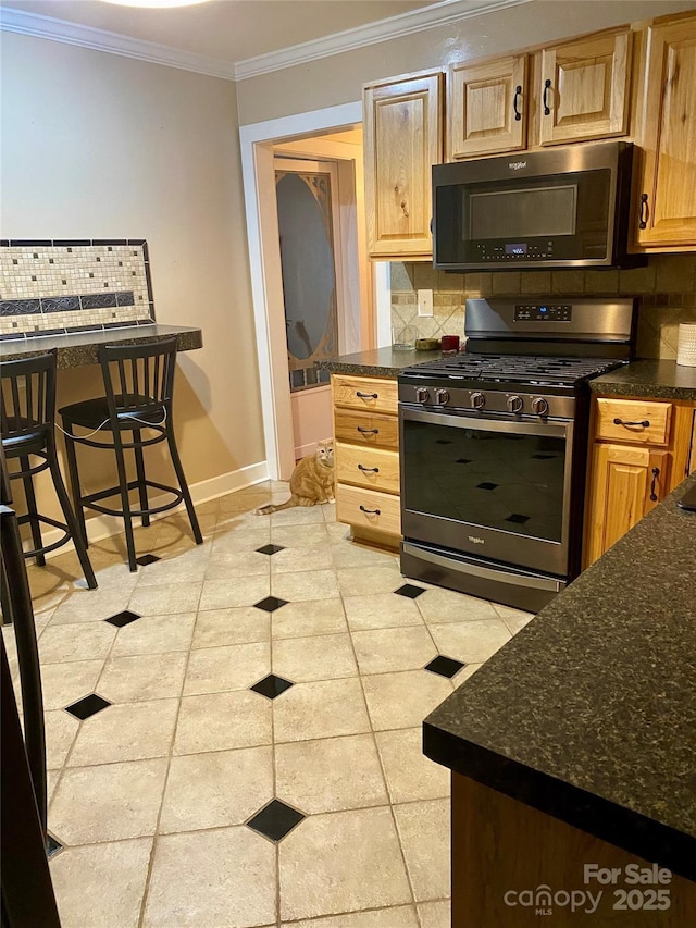 kitchen featuring tasteful backsplash, dark stone countertops, a kitchen breakfast bar, crown molding, and stainless steel range with gas stovetop