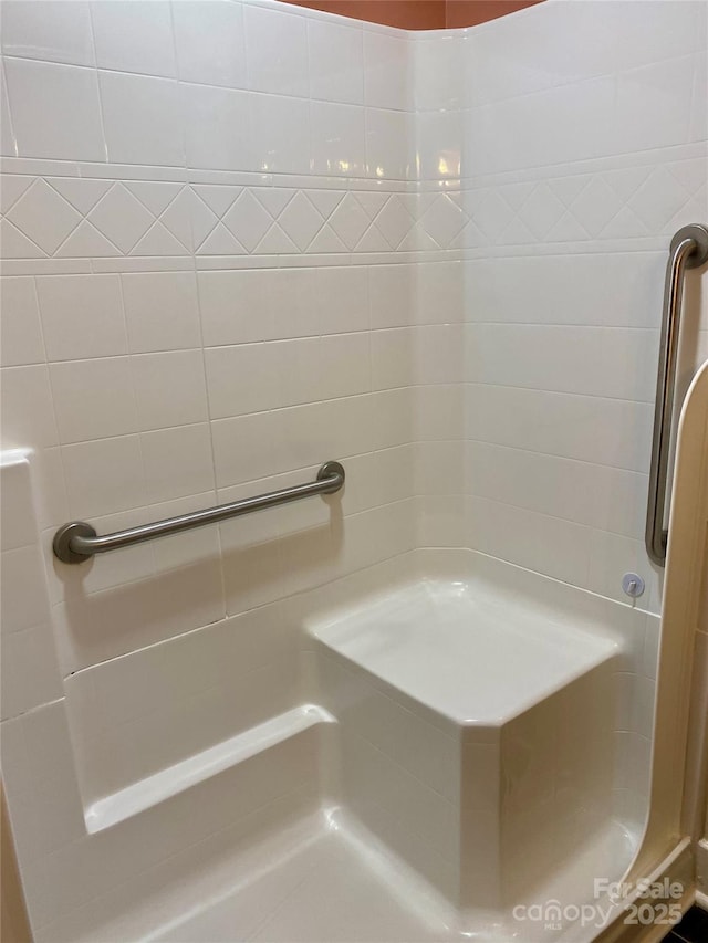 bathroom with a tile shower