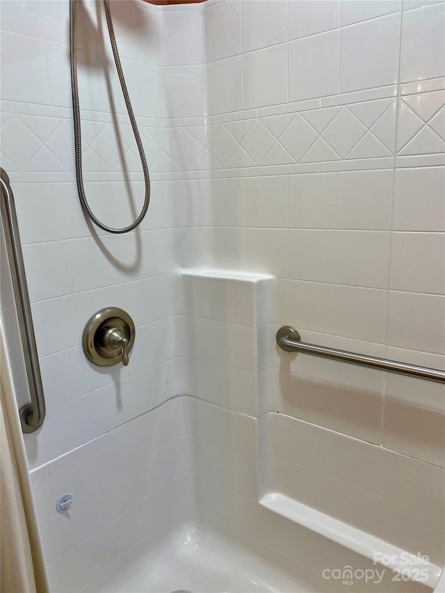 bathroom with tiled shower