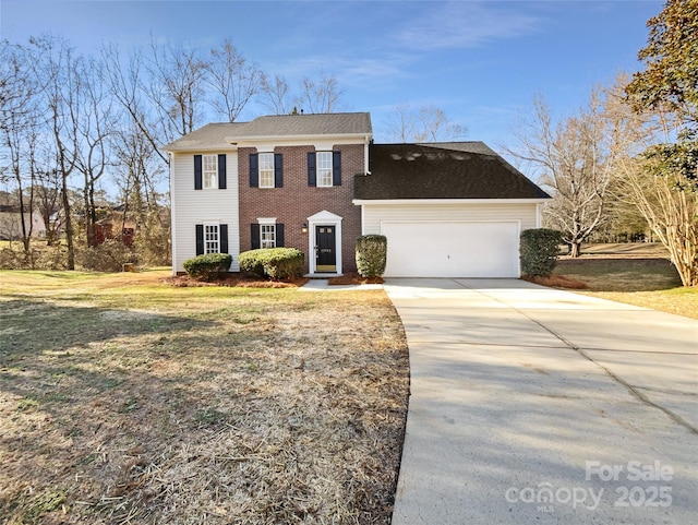 view of front of property featuring a front yard and a garage