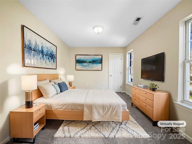 bedroom with dark colored carpet