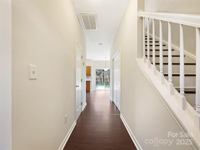 hallway with dark hardwood / wood-style floors