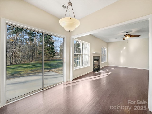 unfurnished living room featuring ceiling fan and hardwood / wood-style floors