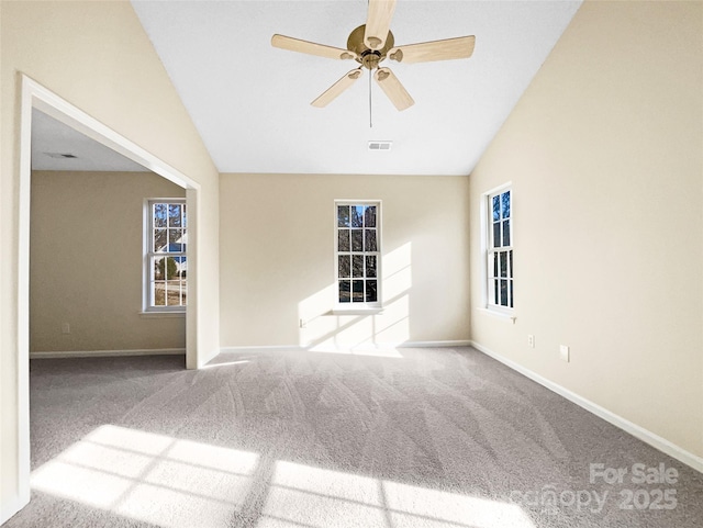 carpeted spare room with ceiling fan and lofted ceiling