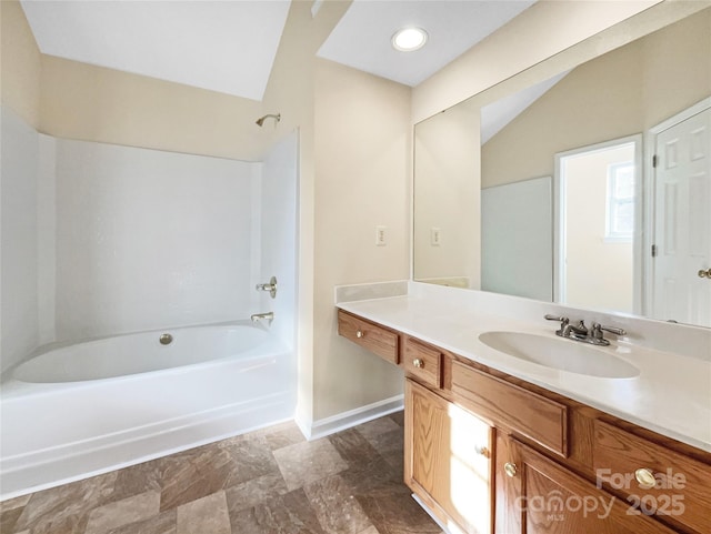 bathroom with lofted ceiling, shower / bath combination, and vanity