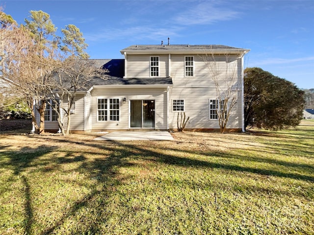 rear view of property featuring a patio area and a yard