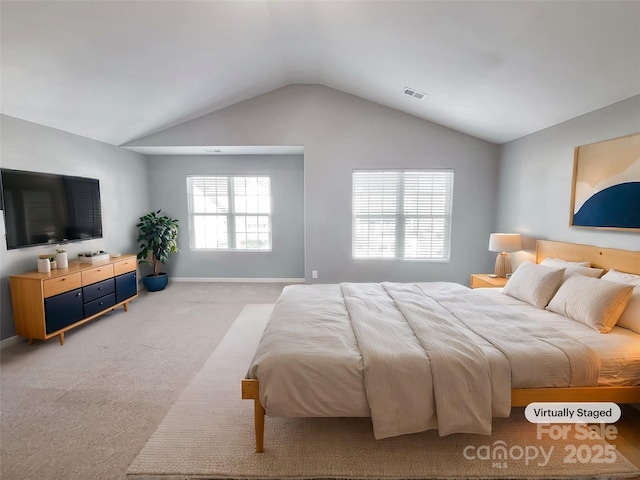 bedroom with light carpet, vaulted ceiling, and multiple windows