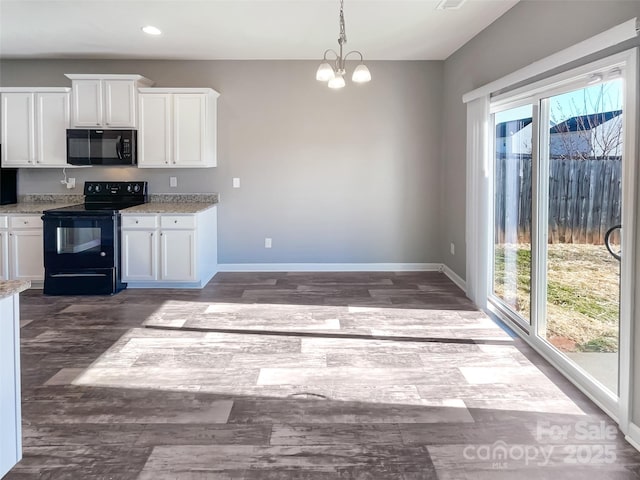 kitchen with pendant lighting, black appliances, white cabinetry, a healthy amount of sunlight, and an inviting chandelier