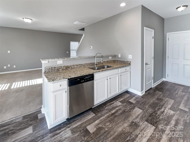 kitchen featuring kitchen peninsula, stone counters, stainless steel dishwasher, white cabinets, and sink