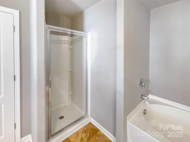 bathroom with tile patterned floors and separate shower and tub