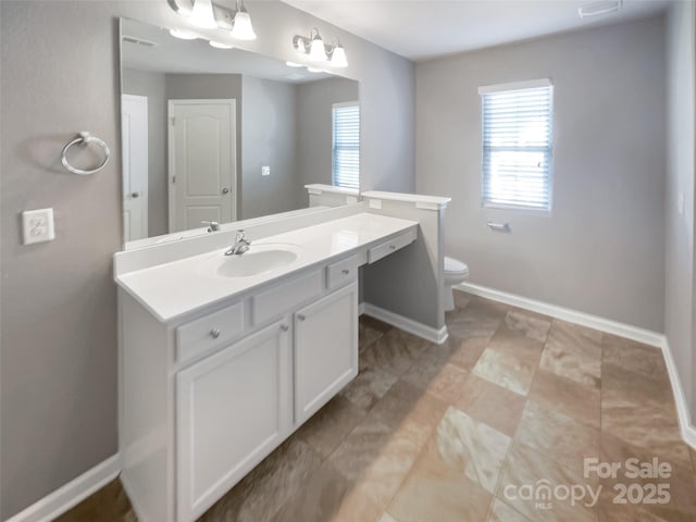 bathroom featuring toilet and vanity