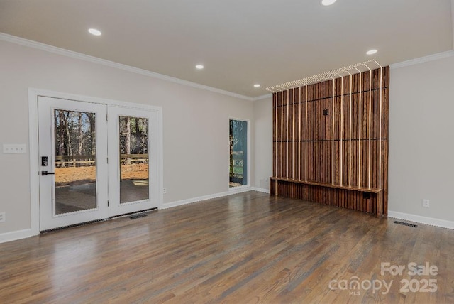 spare room with ornamental molding and hardwood / wood-style flooring