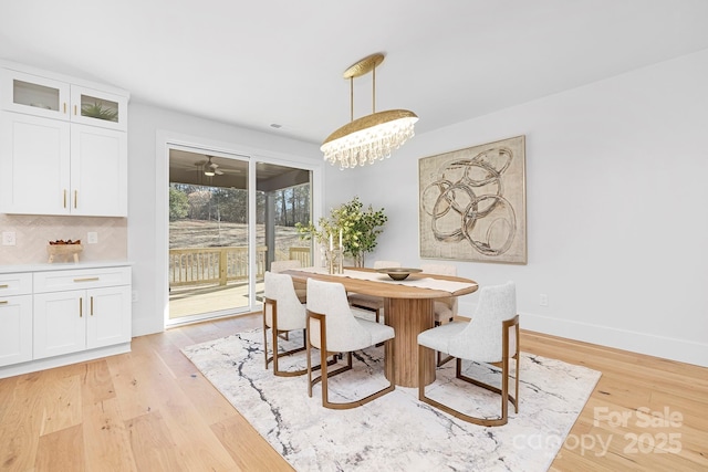 dining area featuring a chandelier and light hardwood / wood-style flooring