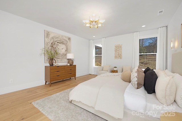 bedroom featuring a notable chandelier and wood-type flooring