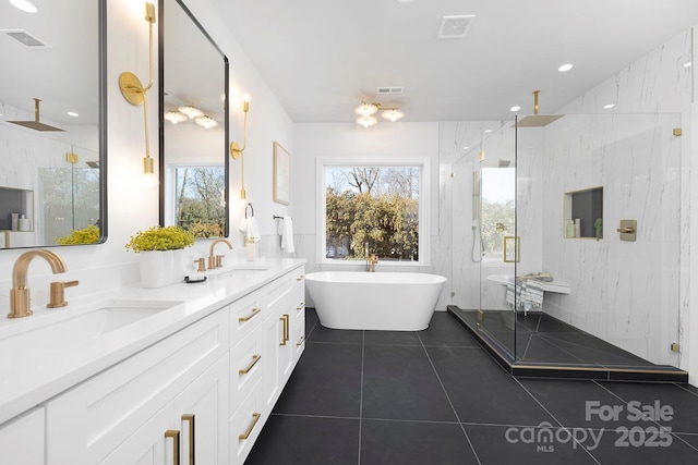 bathroom with tile patterned floors, separate shower and tub, tile walls, and vanity