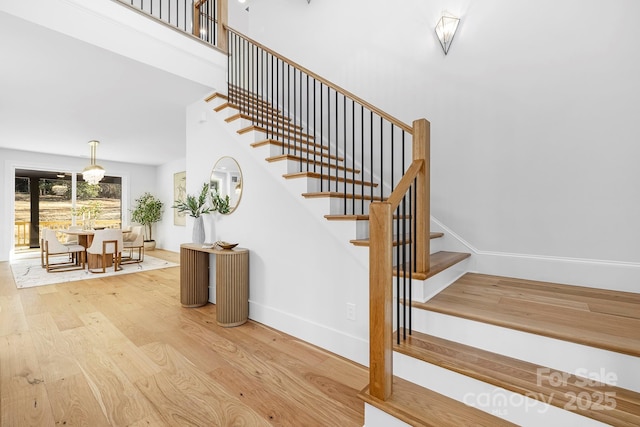 stairs with hardwood / wood-style flooring