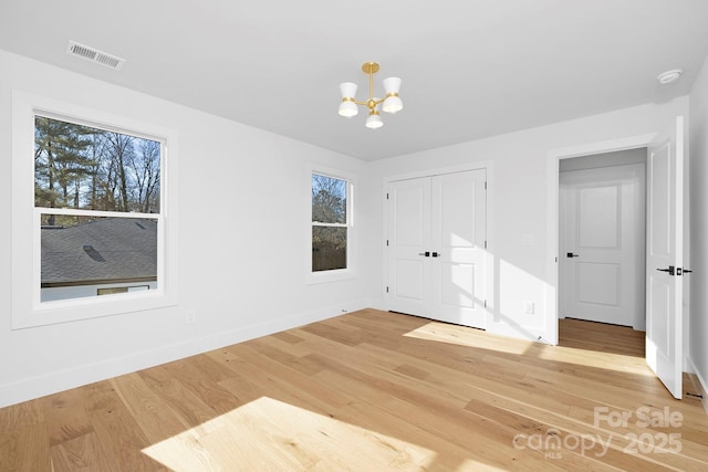 interior space featuring an inviting chandelier and hardwood / wood-style flooring