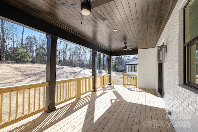 wooden terrace featuring ceiling fan