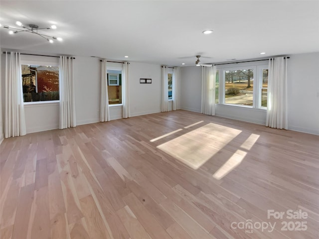 spare room with ceiling fan and light hardwood / wood-style flooring