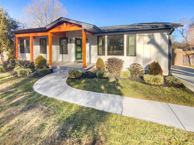 view of front of house with a front lawn and a porch