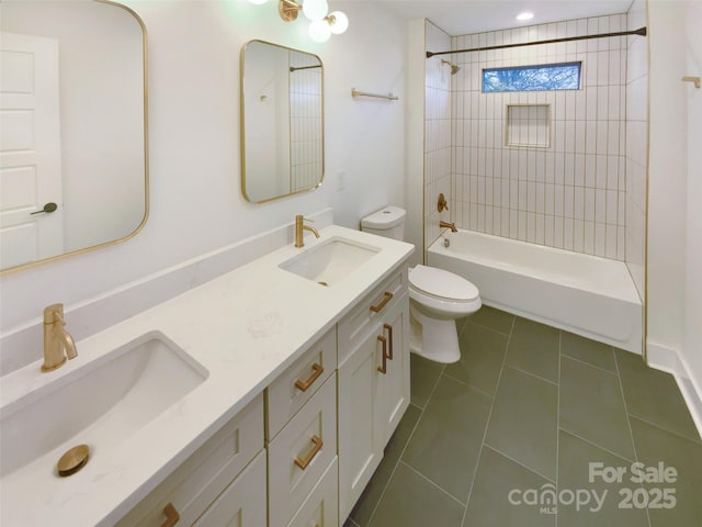 full bathroom with toilet, tiled shower / bath, tile patterned flooring, and vanity