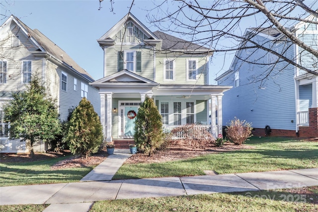 victorian-style house with a front yard