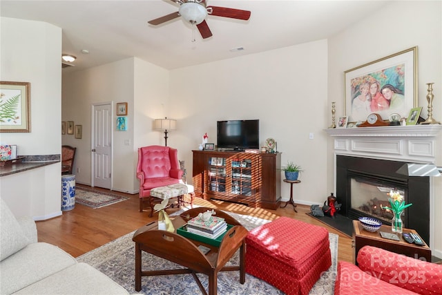 living room with ceiling fan and light hardwood / wood-style flooring