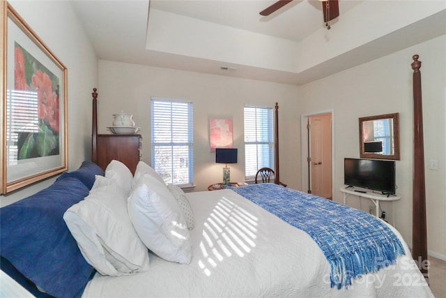 bedroom featuring ceiling fan and a tray ceiling