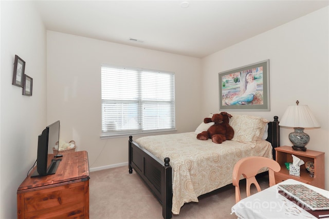 bedroom featuring light colored carpet