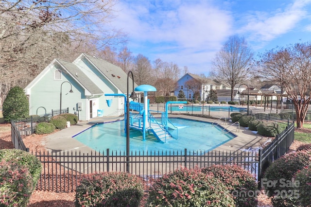 view of swimming pool with a playground