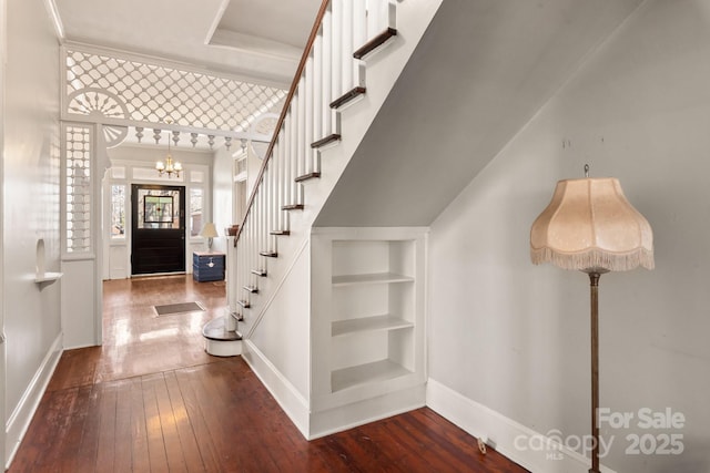 foyer featuring an inviting chandelier and hardwood / wood-style floors