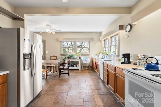 kitchen with ceiling fan, sink, and white appliances