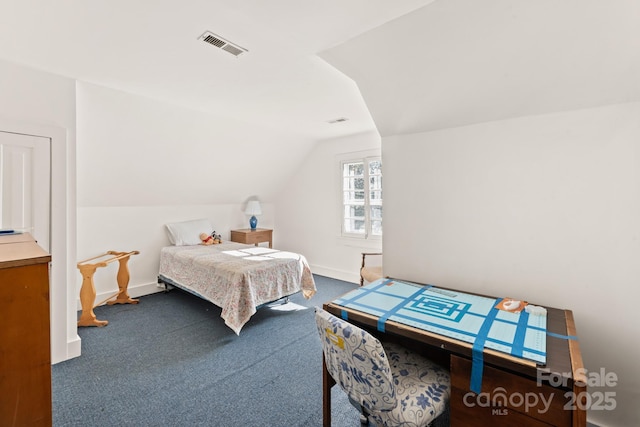 carpeted bedroom with lofted ceiling