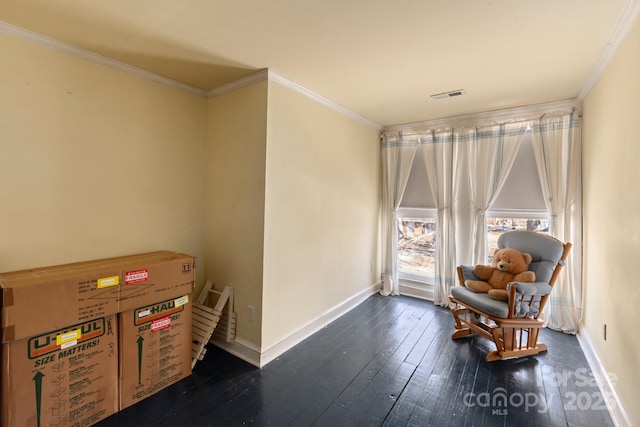 sitting room featuring dark wood-type flooring and crown molding