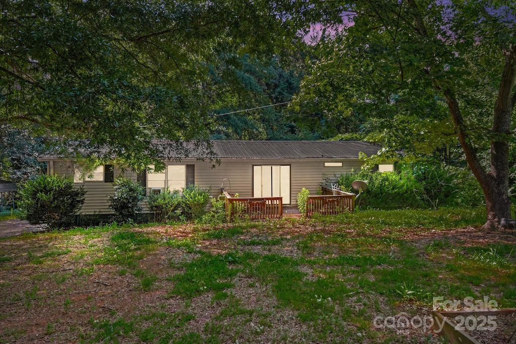 back of property featuring a wooden deck