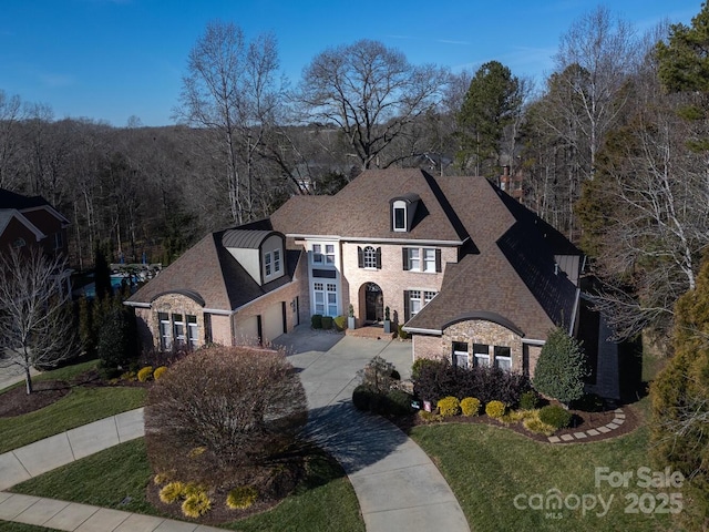 french country inspired facade with a front lawn