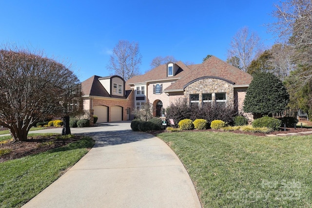 french country inspired facade with a front lawn and a garage