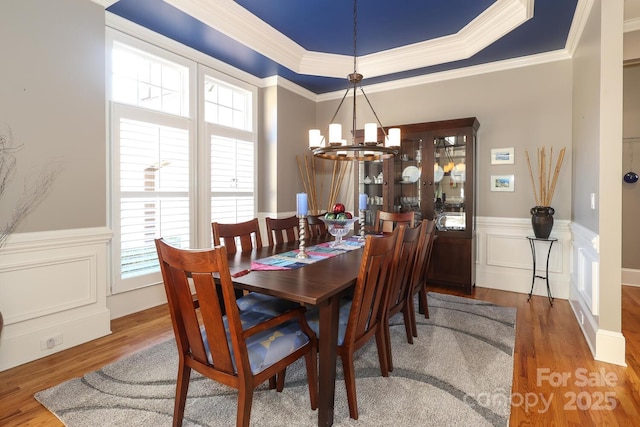 dining room featuring ornamental molding, a chandelier, and hardwood / wood-style flooring