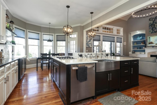 kitchen with sink, white cabinetry, built in features, and stainless steel appliances