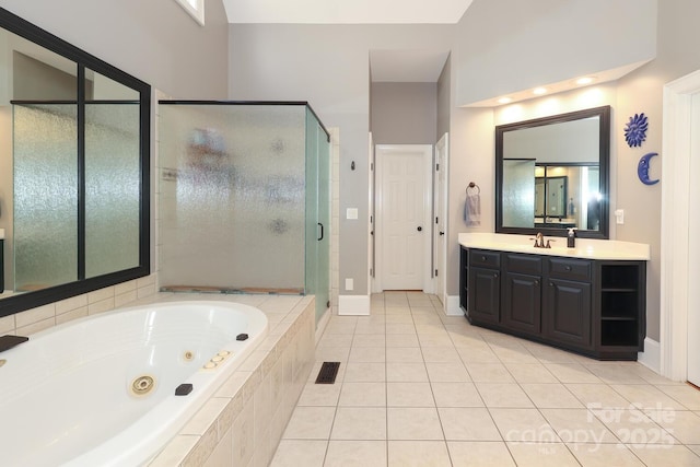 bathroom with separate shower and tub, vanity, and tile patterned floors