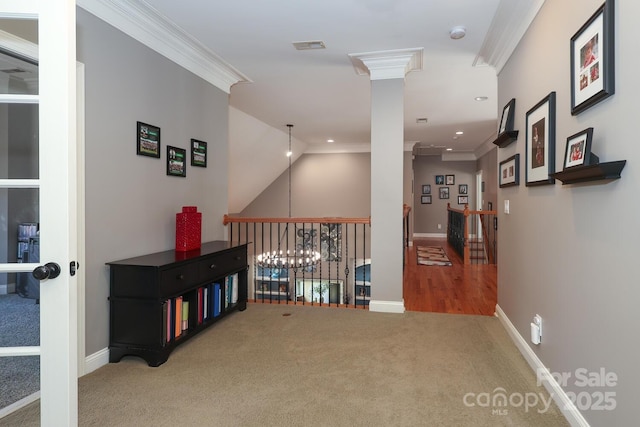 corridor with carpet, lofted ceiling, and ornamental molding