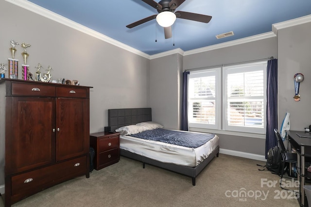 carpeted bedroom with ceiling fan and ornamental molding